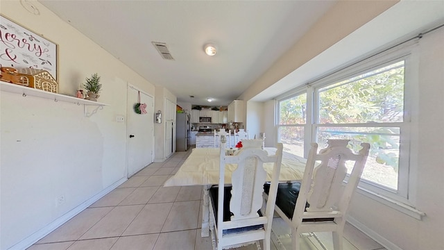 dining area featuring light tile patterned floors