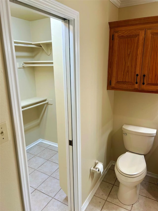 bathroom featuring toilet and tile patterned flooring