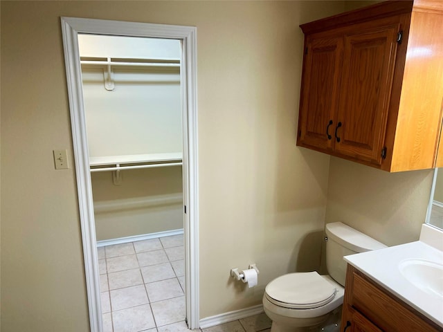 bathroom featuring tile patterned flooring, vanity, and toilet