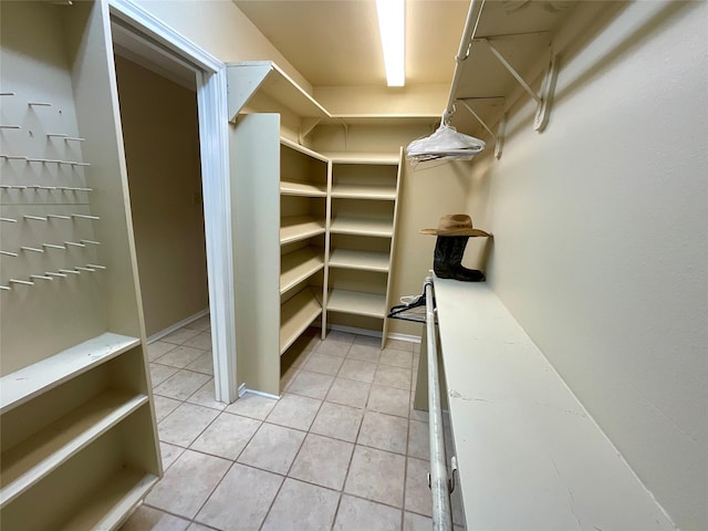 walk in closet featuring light tile patterned flooring