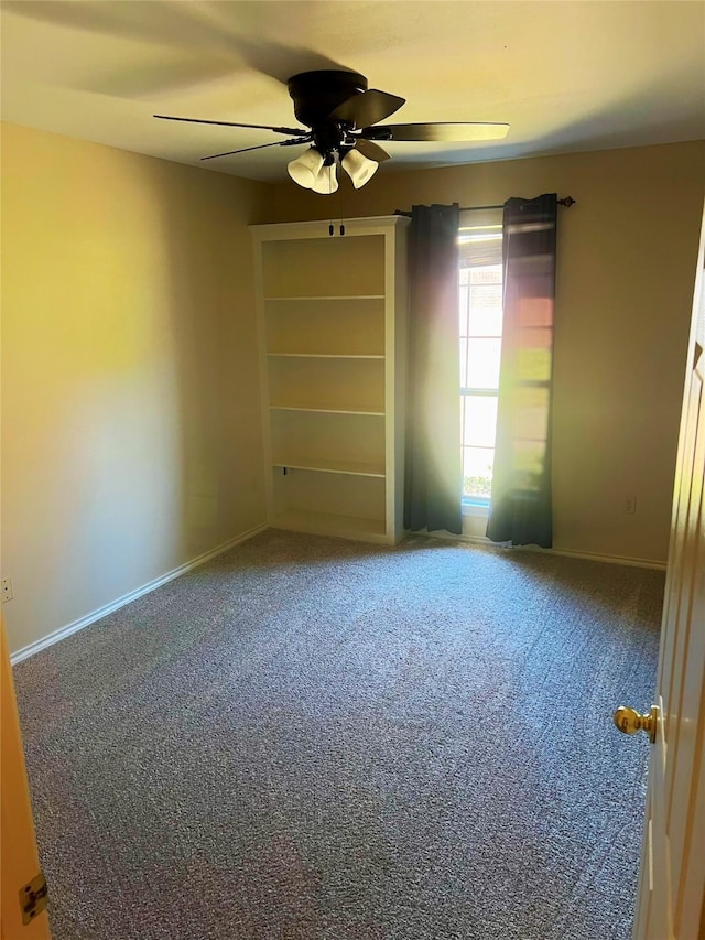 unfurnished room featuring ceiling fan and carpet flooring