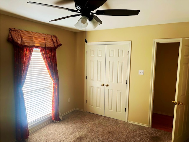 unfurnished bedroom featuring carpet floors, ceiling fan, and a closet