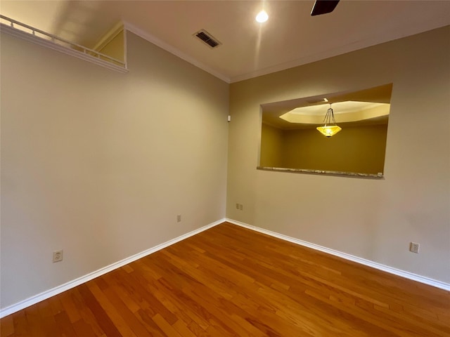 unfurnished room featuring wood-type flooring and ornamental molding