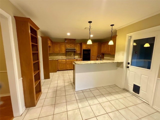 kitchen with sink, light tile patterned floors, black appliances, decorative light fixtures, and kitchen peninsula