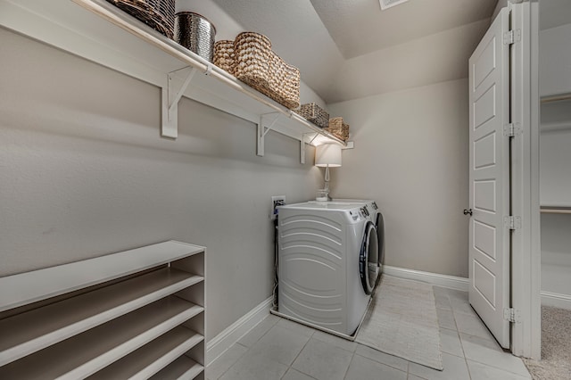 laundry area featuring independent washer and dryer and light tile patterned flooring