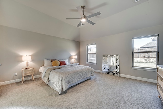 carpeted bedroom with ceiling fan, lofted ceiling, and multiple windows