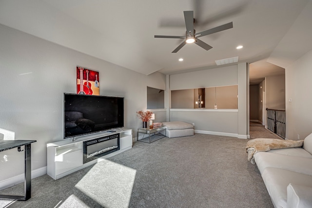 carpeted living room featuring ceiling fan and lofted ceiling