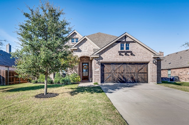 view of front of house featuring a front lawn and a garage