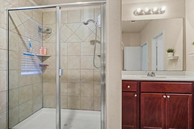 bathroom with a shower with door and vanity