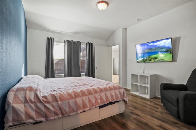 bedroom featuring lofted ceiling and dark wood-type flooring