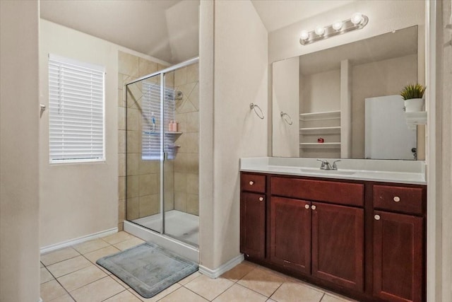 bathroom featuring tile patterned floors, vanity, and a shower with door