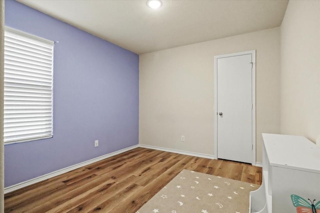 spare room with wood-type flooring