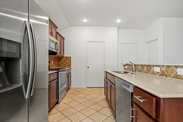 kitchen featuring decorative backsplash, light tile patterned flooring, sink, and stainless steel appliances