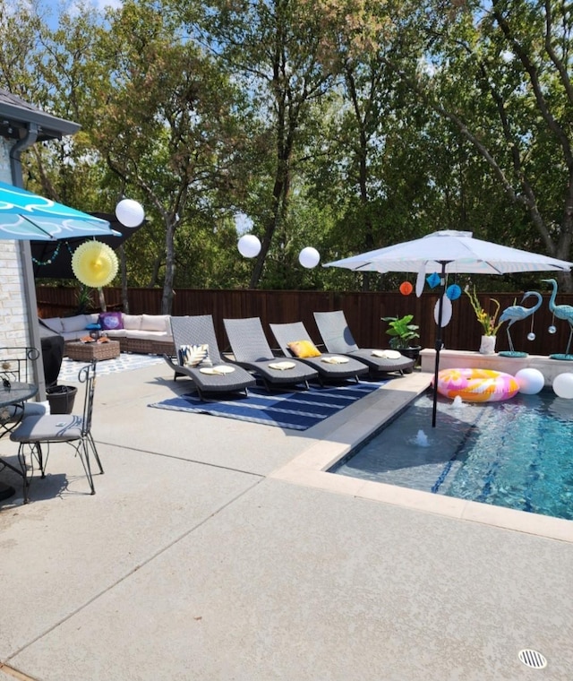 view of swimming pool featuring outdoor lounge area, a patio area, and fence