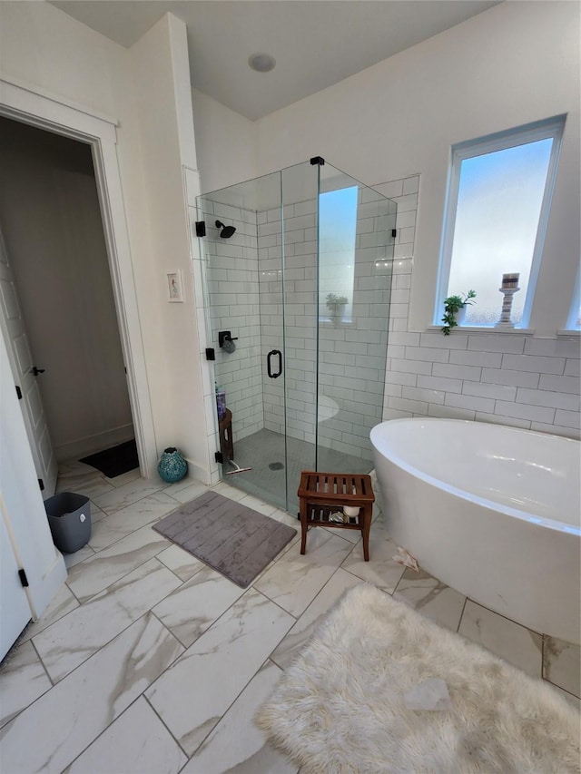 bathroom with shower with separate bathtub