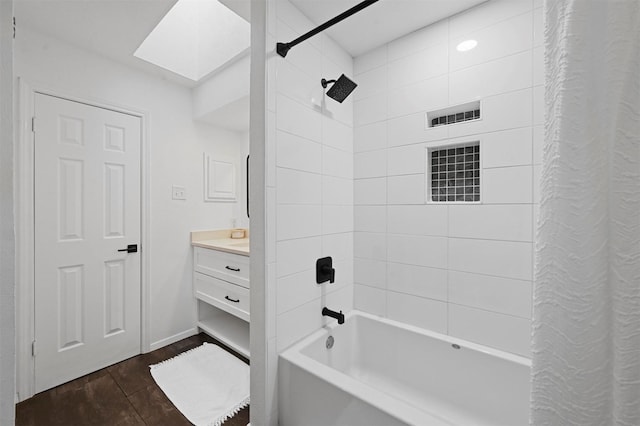 3635 Garden Brook Dr Unit 1200, Farmers Branch, TX 75234 - bathroom with a skylight, shower / bath combo with shower curtain, wood finished floors, and vanity