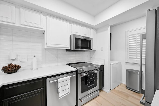 3635 Garden Brook Dr Unit 1200, Farmers Branch, TX 75234 - kitchen featuring stainless steel appliances, light wood-style flooring, white cabinets, and backsplash