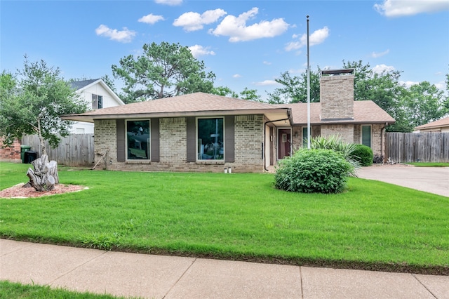 ranch-style house with a front lawn