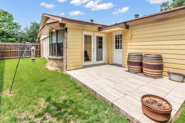 exterior space featuring french doors and a lawn