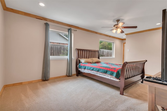 bedroom featuring ornamental molding, light colored carpet, and ceiling fan