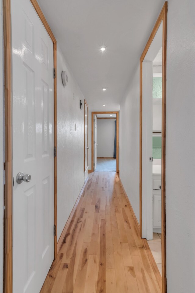 hallway with light wood-type flooring