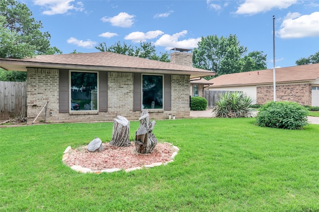 back of property featuring a lawn