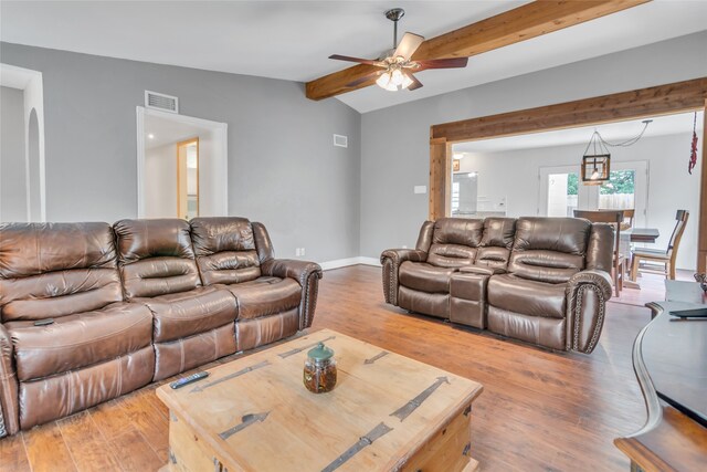 living room featuring hardwood / wood-style floors, lofted ceiling with beams, and ceiling fan