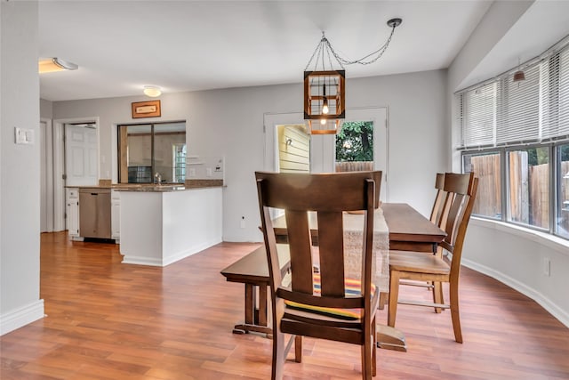 dining area featuring a chandelier and light hardwood / wood-style flooring