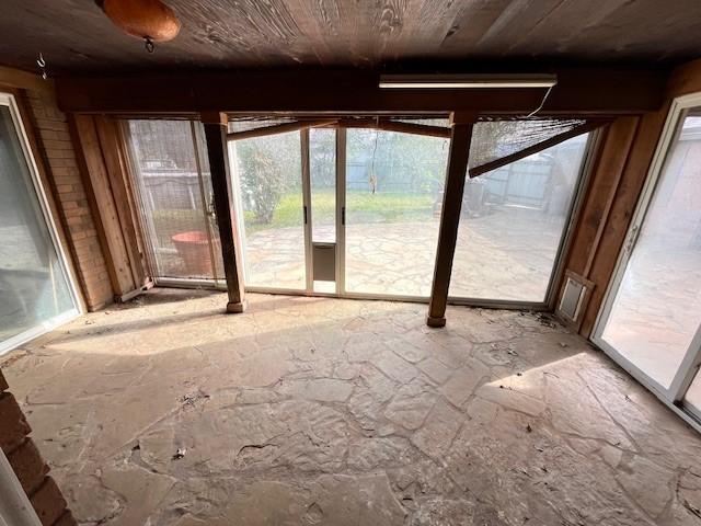unfurnished sunroom with wood ceiling