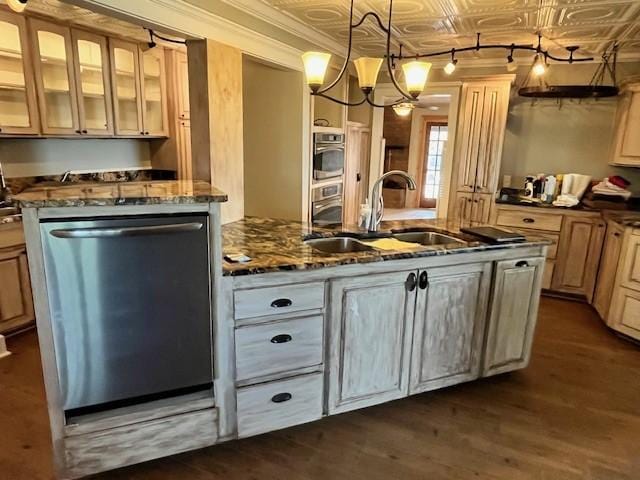 kitchen featuring sink, hanging light fixtures, stainless steel appliances, dark hardwood / wood-style floors, and dark stone counters