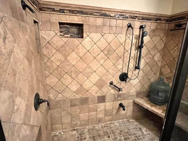 bathroom with tiled shower
