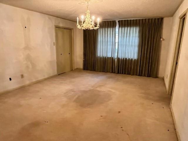 unfurnished room featuring an inviting chandelier
