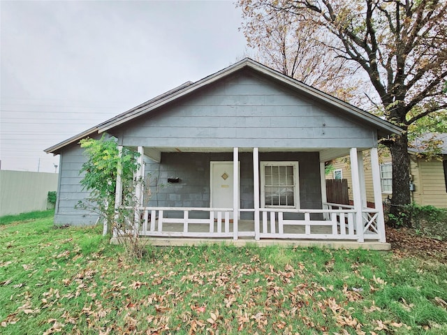 bungalow-style home featuring a porch and a front yard