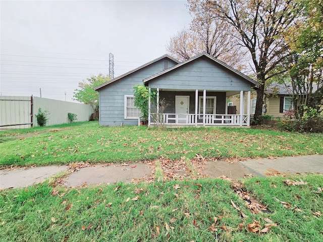 view of front of house featuring covered porch and a front yard