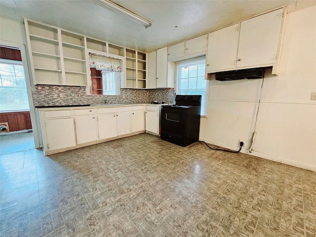 kitchen featuring tasteful backsplash, white cabinets, and black range with electric cooktop