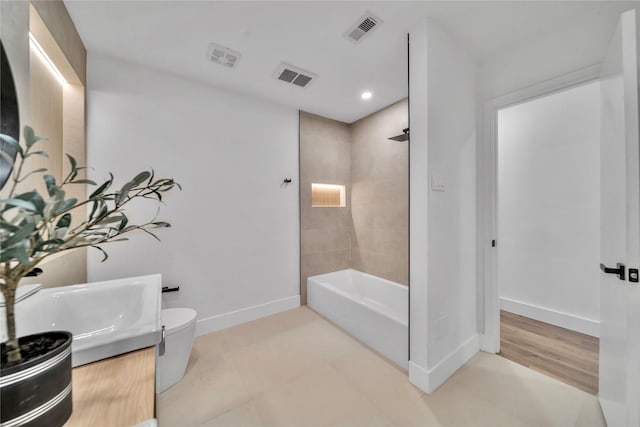 full bathroom with tile patterned flooring, vanity, toilet, and tiled shower / bath combo