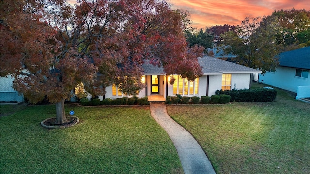 view of property hidden behind natural elements with a lawn