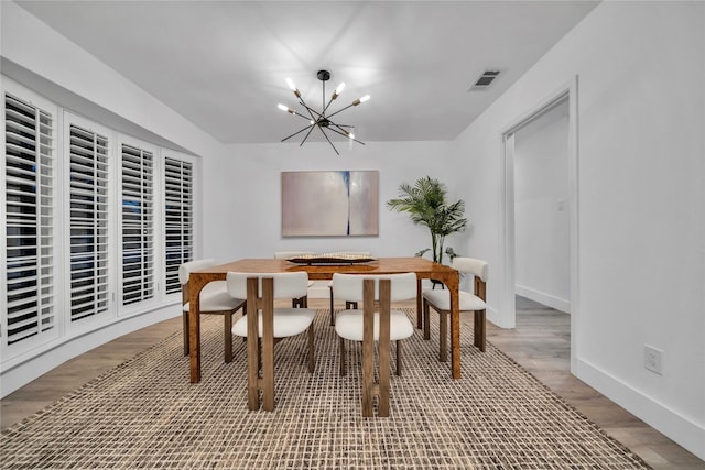 dining room featuring a chandelier and wood-type flooring