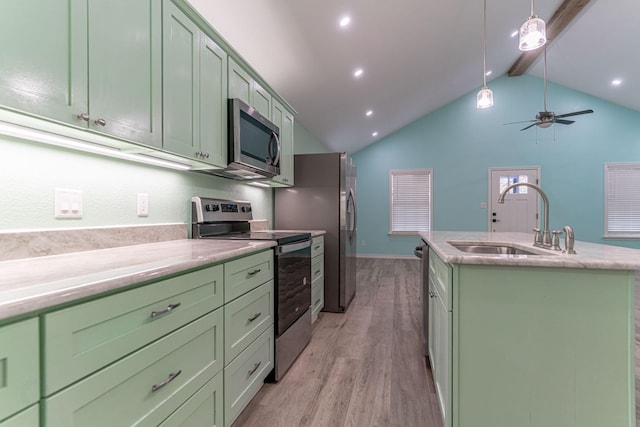 kitchen with stainless steel appliances, sink, green cabinetry, vaulted ceiling with beams, and an island with sink