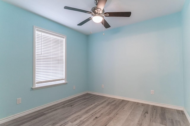 spare room with light hardwood / wood-style flooring and ceiling fan