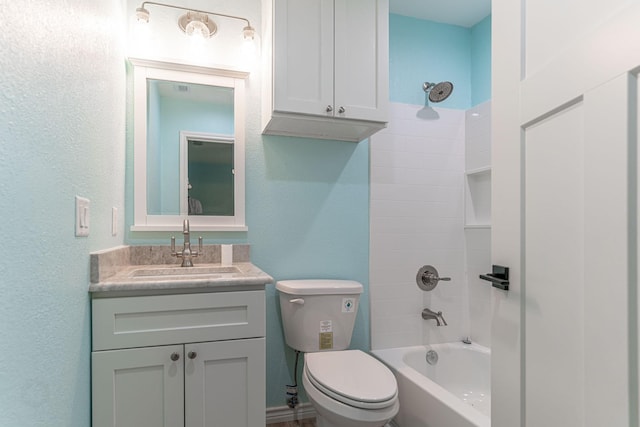 full bathroom featuring washtub / shower combination, vanity, and toilet