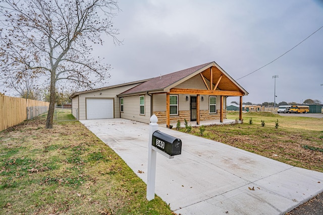 ranch-style house with a front lawn, a porch, and a garage