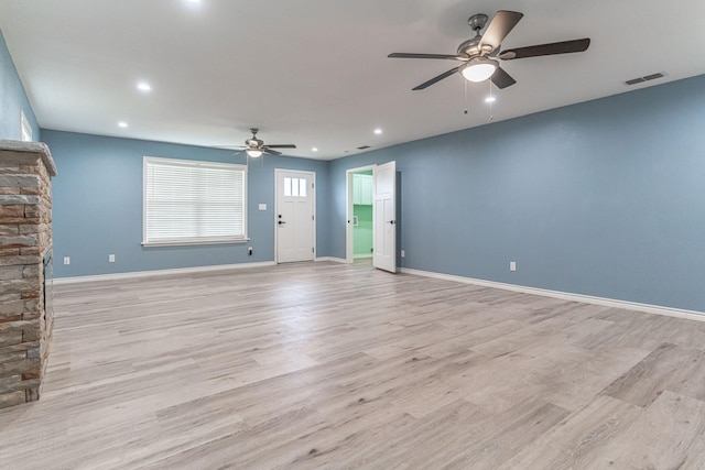 unfurnished living room featuring ceiling fan and light wood-type flooring