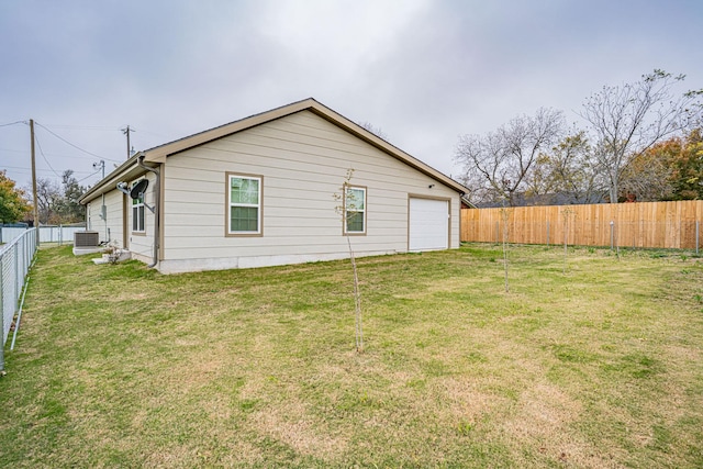 view of property exterior featuring a yard, central AC, and a garage