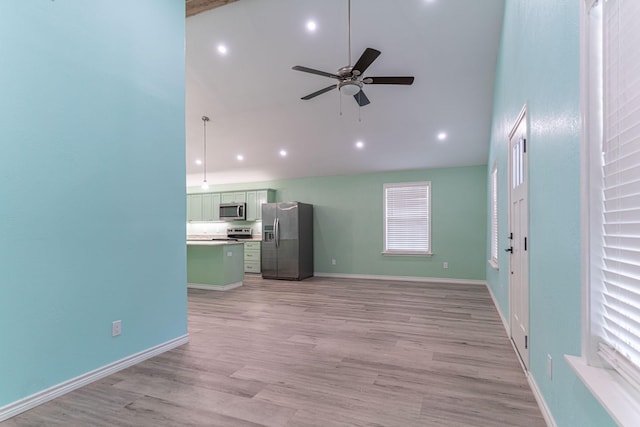 unfurnished living room featuring ceiling fan, light hardwood / wood-style floors, and high vaulted ceiling