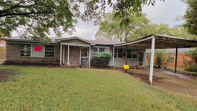 single story home featuring a carport and a front yard