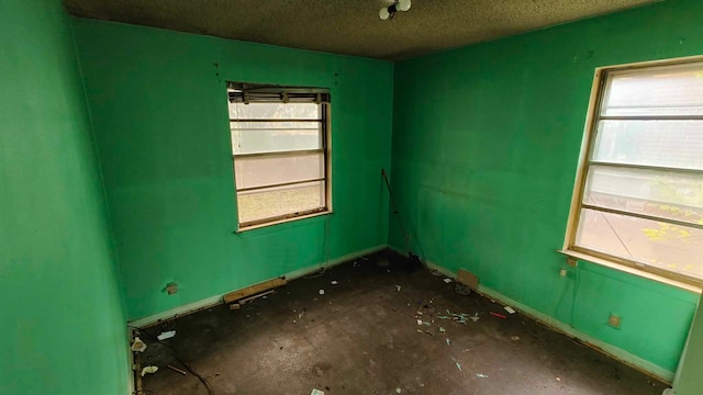 spare room with a textured ceiling