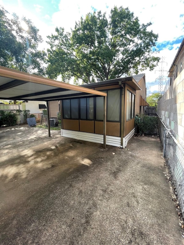 view of property exterior featuring a carport