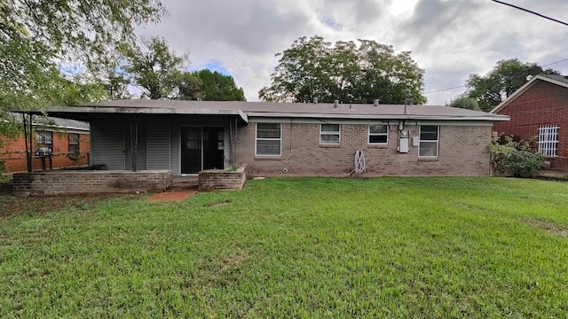 back of house with a lawn