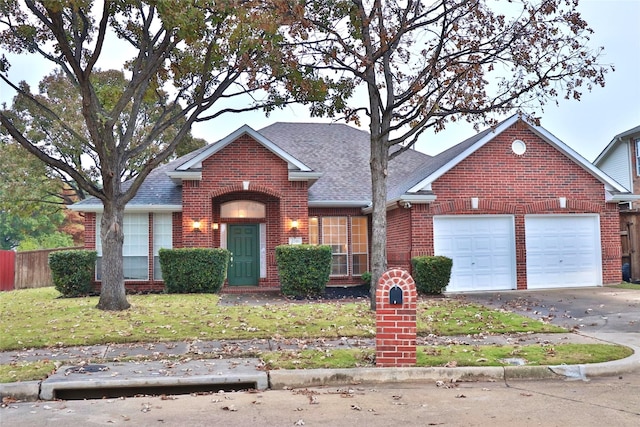 view of front of property with a garage and a front yard